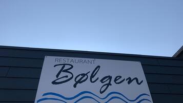 A restaurant sign with the name 'Bolgen' and a wave design below the name.