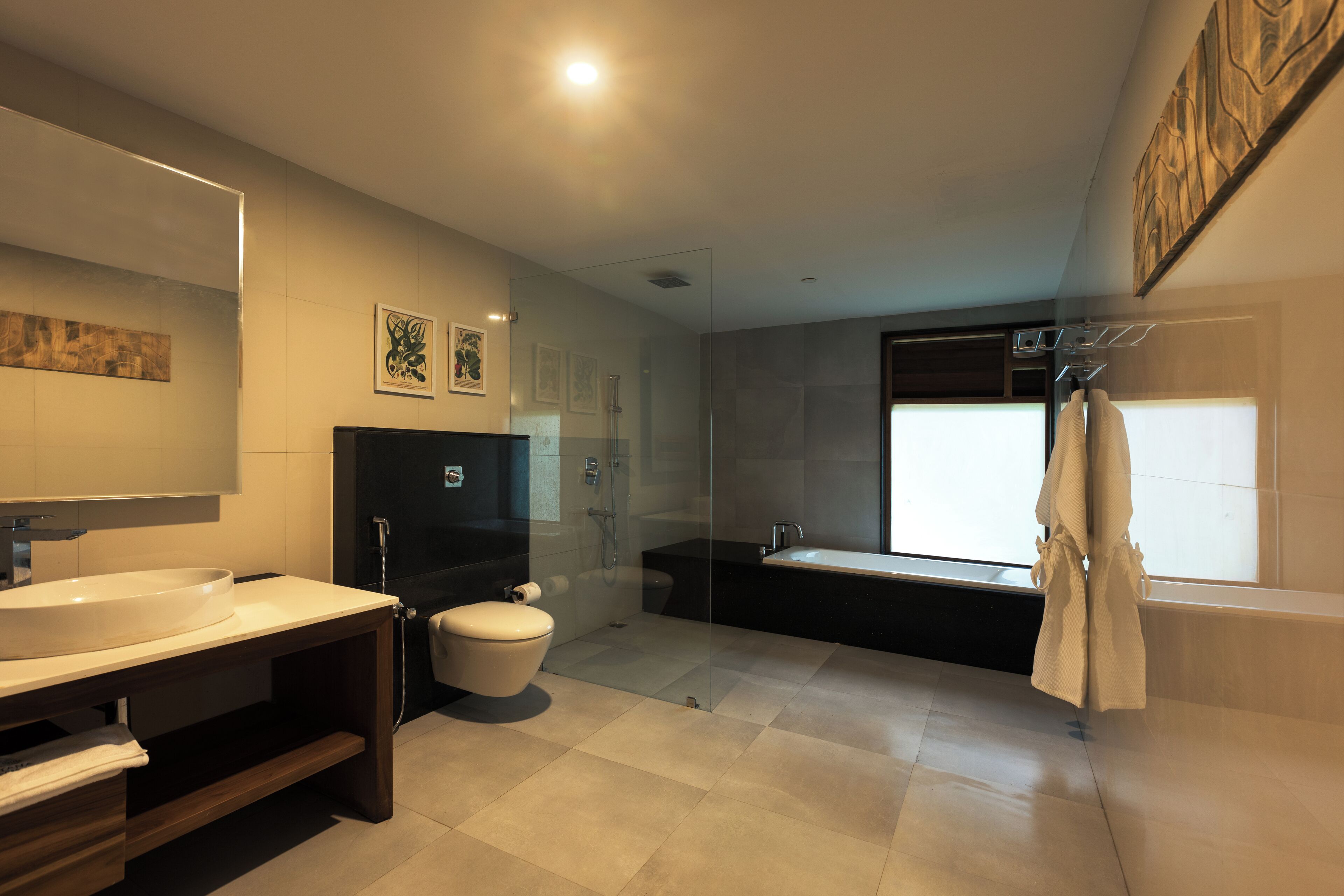 A modern bathroom with a large sink, toilet, and bathtub.