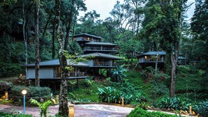 A multi-story resort with a lush, forested environment.
