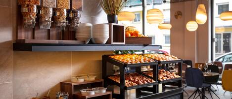 A buffet area with various food items and condiments.