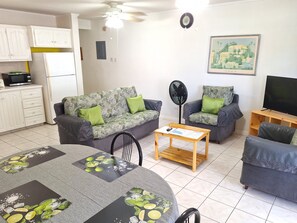 Deluxe Apartment (1 Bedroom)  | Living area | Flat-screen TV - Cumber's Tropical Apartments (Oistins)