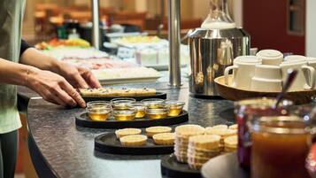 A buffet setup with various food items and beverages.