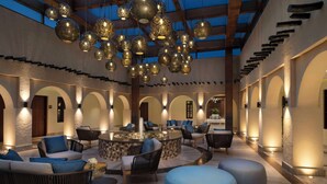 A spacious lobby with a high ceiling, ornate hanging lamps, and a central water feature. - Souq Al Wakra Hotel Qatar by Tivoli (Al Wakrah)