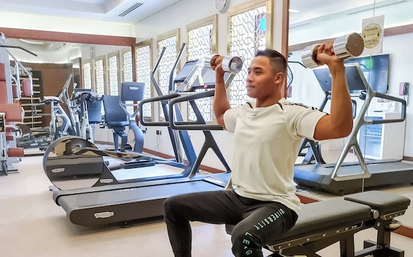 A gym with exercise equipment, including treadmills and weight machines. - Souq Al Wakra Hotel Qatar by Tivoli (Al Wakrah)