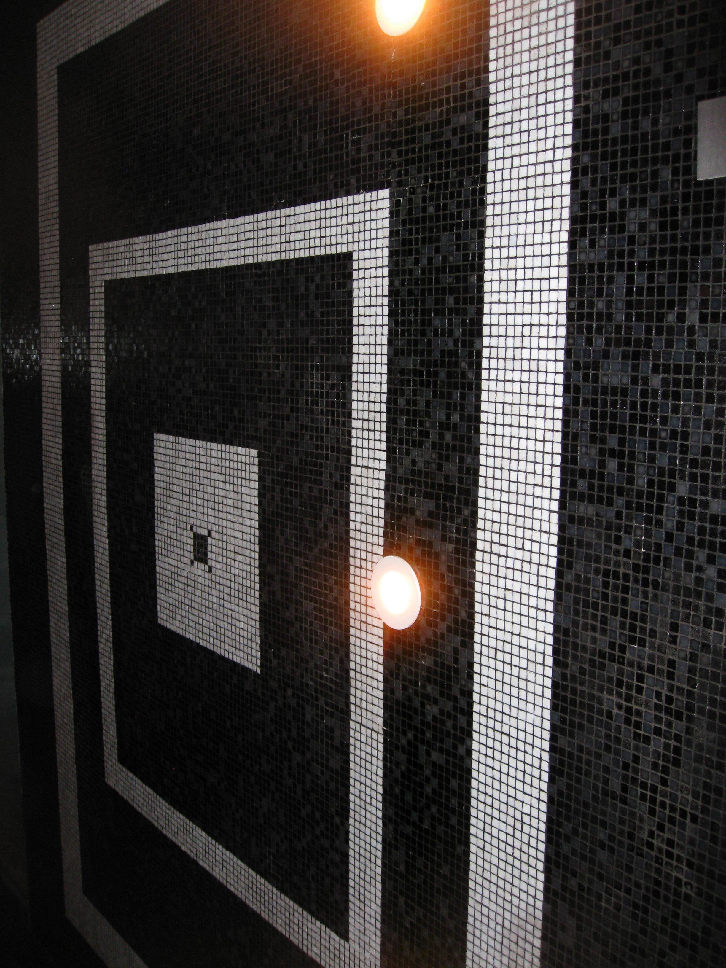 A tiled wall with a square pattern and a smaller square inset.