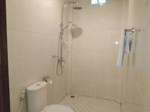 A small, clean bathroom with a toilet, shower, and towel rack. - Qiul Guest House (Ubud)
