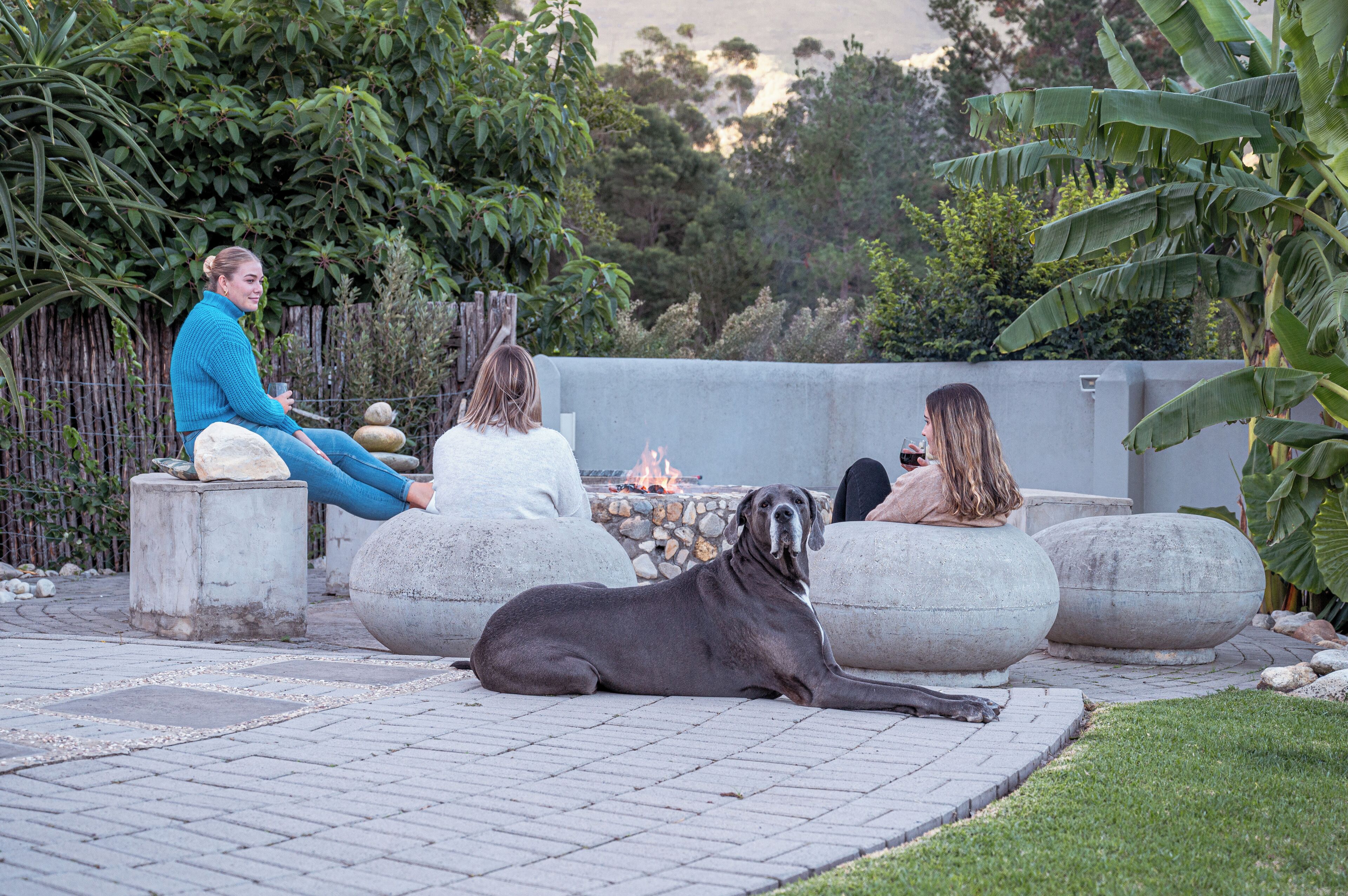 A patio area with stone seating and a fire pit.