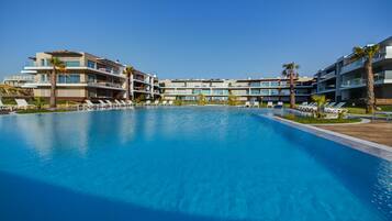 Indoor pool, outdoor pool, pool umbrellas, pool loungers