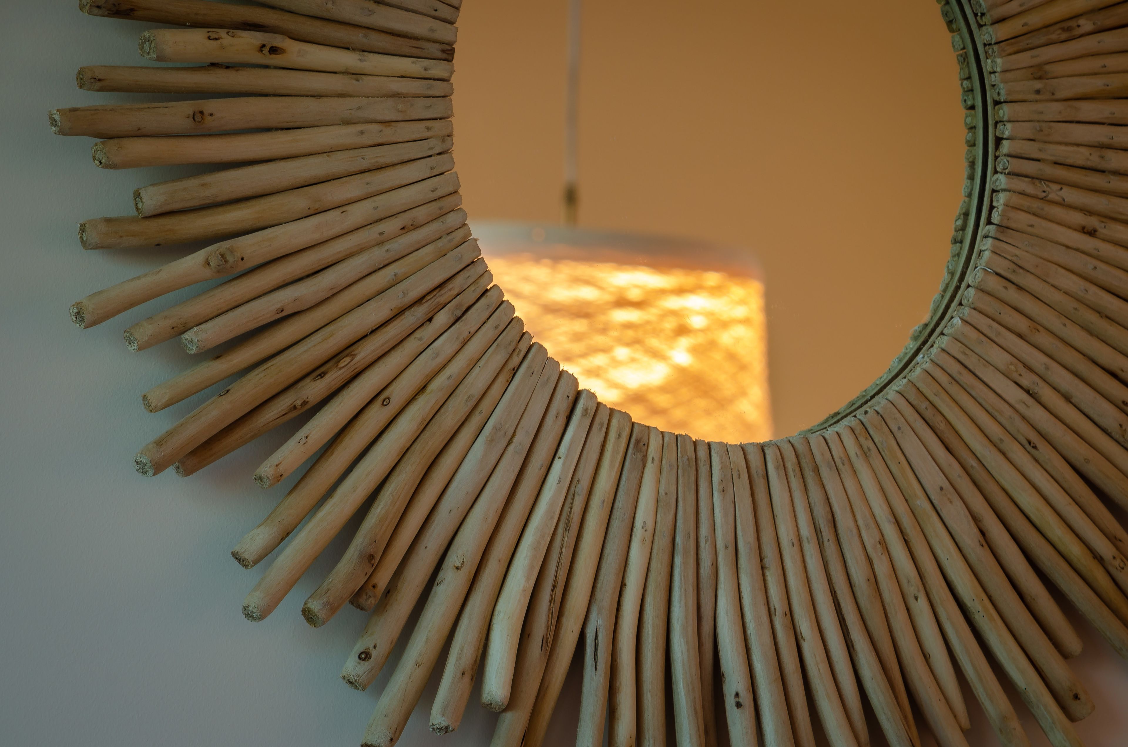 A circular mirror with a bamboo frame.