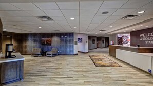 A spacious lobby with a reception desk, seating area, and a 'Welcome to the Gold State' sign. - Hampton Inn & Suites San Jose Airport (San Jose)