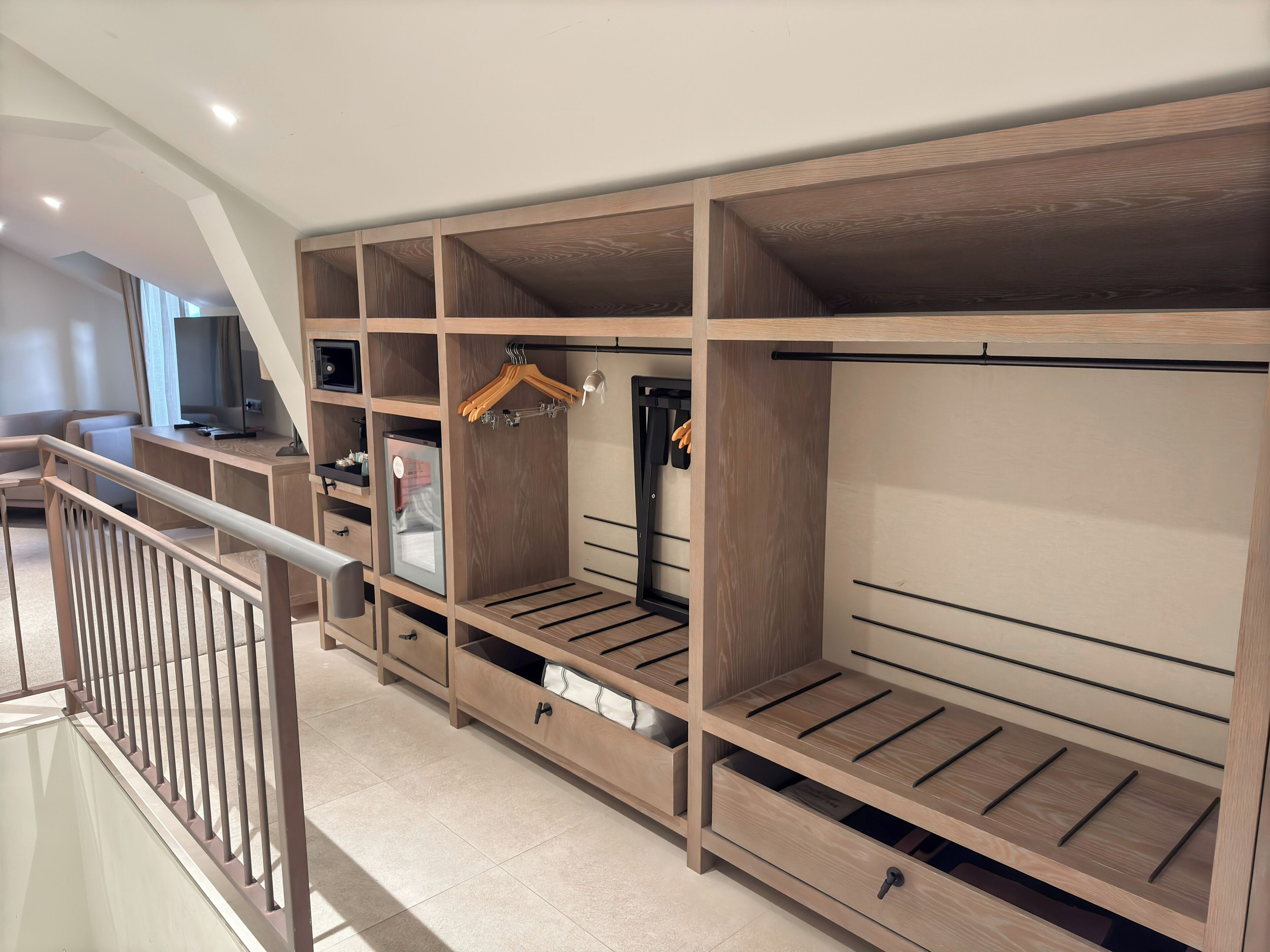 Un amplio vestidor con múltiples estantes, cajones y espacio para colgar.