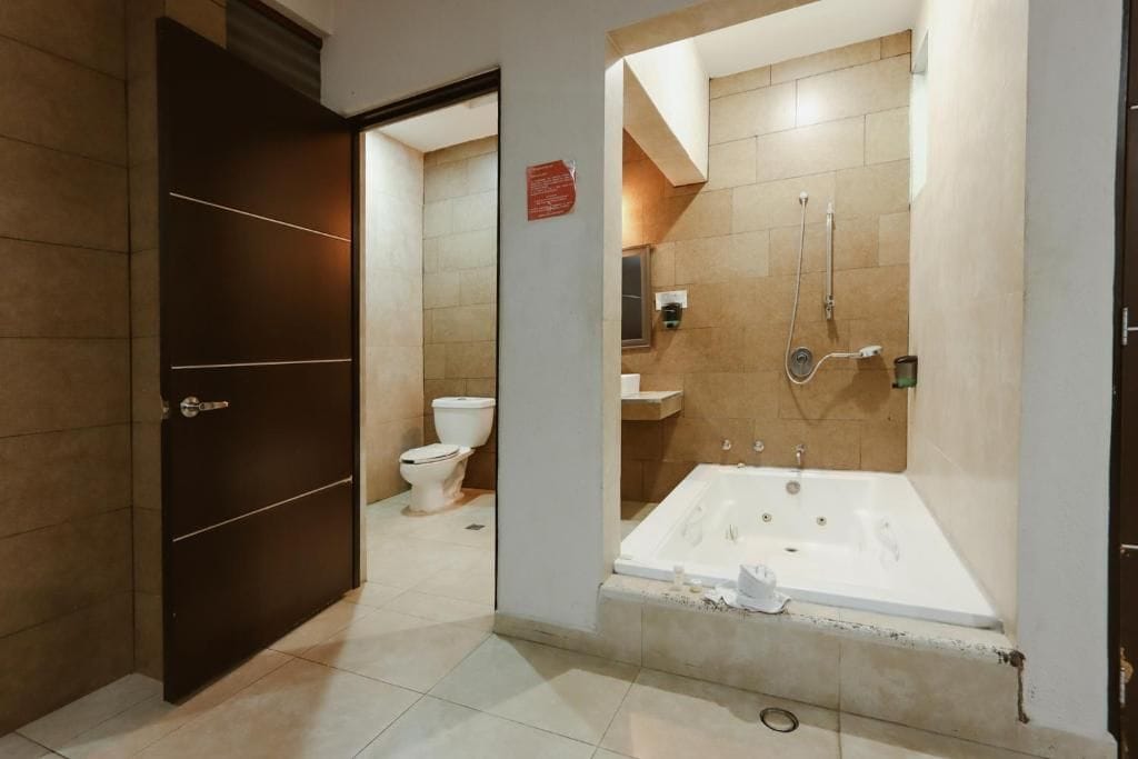 A bathroom with a bathtub, toilet, and sink.