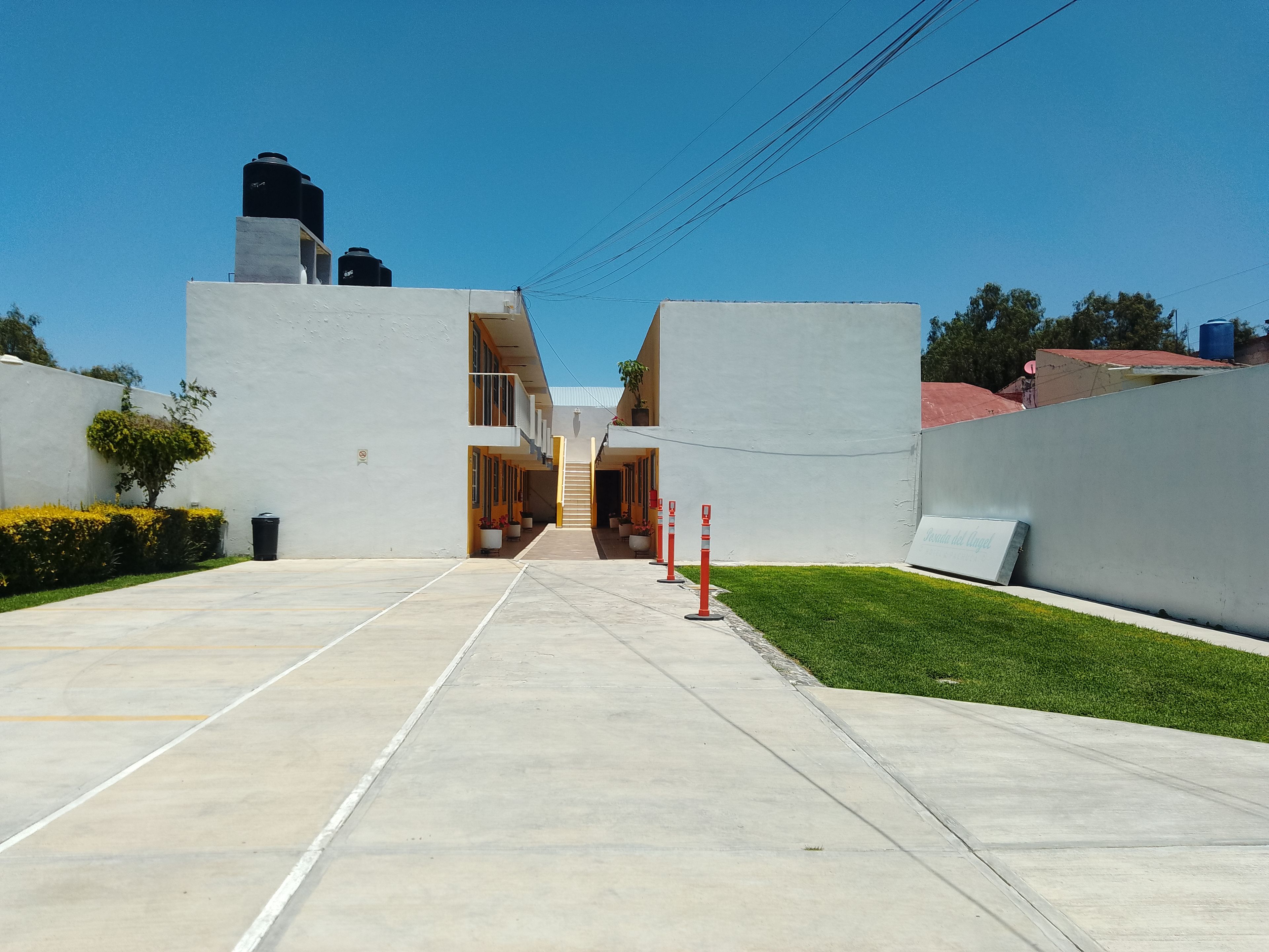 A modern building with a central corridor leading to a staircase.