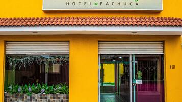 A hotel named Posada del Ángel with a yellow facade and a sign above the entrance.