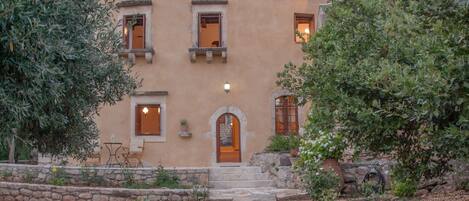 A building with a stone pathway leading to a wooden door.