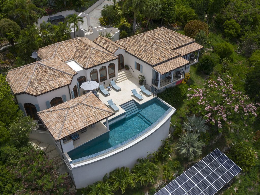 A large, modern house with a swimming pool, multiple rooms, and a garden.
