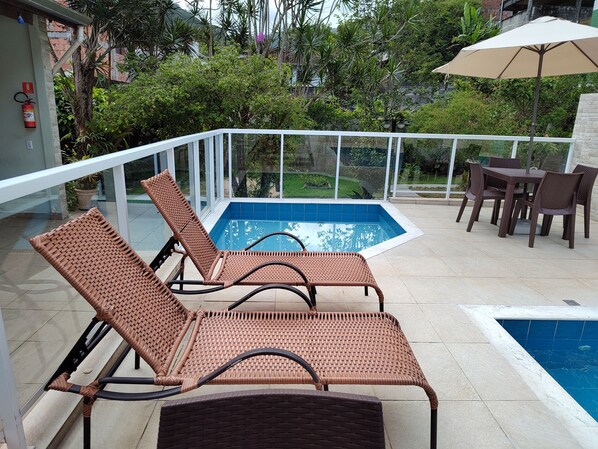 Outdoor pool, open 10 AM to 9 PM, pool umbrellas, pool loungers