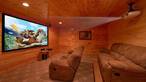 A cozy room with a large flat-screen TV, two leather sofas, and a wooden ceiling. - Natural Attractions Apartment 3 (Gatlinburg)