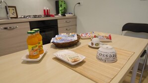 A breakfast table with various food items and a coffee pot. - Efesto Bed & Breakfast (Catania)