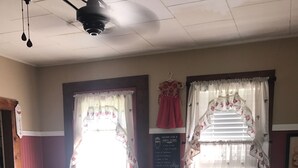 A kitchen with a central island, white cabinets, and a chalkboard with a recipe.