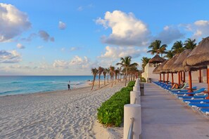On the beach, sun-loungers
