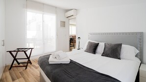 Un dormitorio con cama, escritorio y silla.