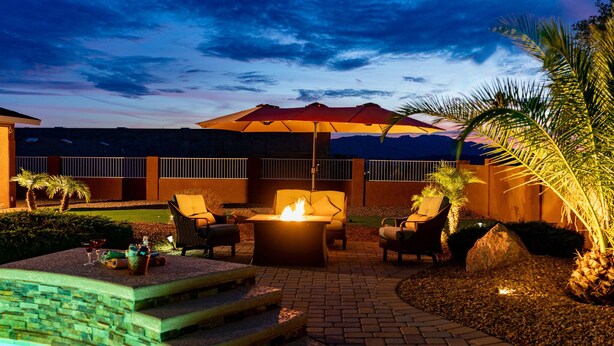 An outdoor patio area with a fire pit, seating, and a view of mountains. - Tequila Sunrise, Large Pool Home (Lake Havasu City)