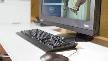 A computer monitor displaying a person using a smartphone.