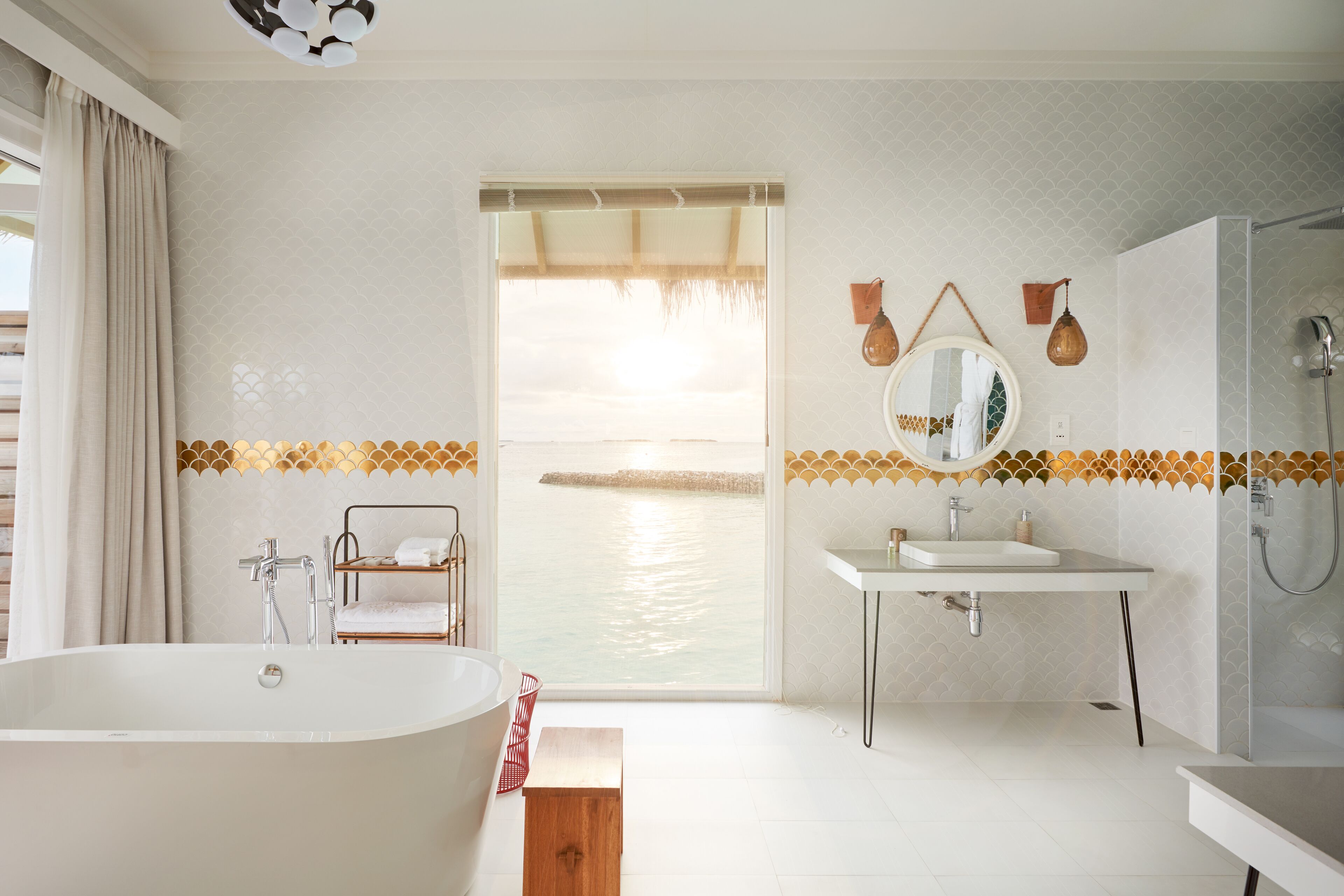 A modern bathroom with a freestanding bathtub, a shower, and a vanity with a mirror.