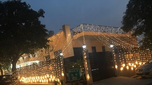 A building with a covered entrance decorated with string lights. - Winsome Guest House (Noida)