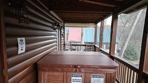 A hot tub with safety rules, wooden walls, and a view of the outside. - Casa Del Rio | Ellijay, GA (Ellijay)