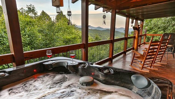 A hot tub with a view of mountains, wooden deck, and outdoor seating. - Moonlight Hideaway | Ellijay, GA (Ellijay)