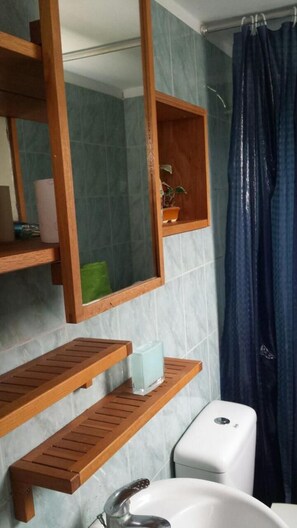A bathroom with a wooden vanity, a sink, and a shower curtain. - Marysplacestalis (Hersonissos)