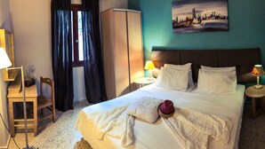 A hotel room with a bed, two bedside tables, a chair, a wardrobe, and a window with curtains. - Marysplacestalis (Hersonissos)
