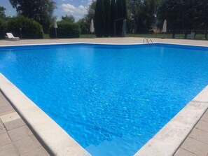 Seasonal outdoor pool, open 9 AM to 7 PM, pool umbrellas, pool loungers
