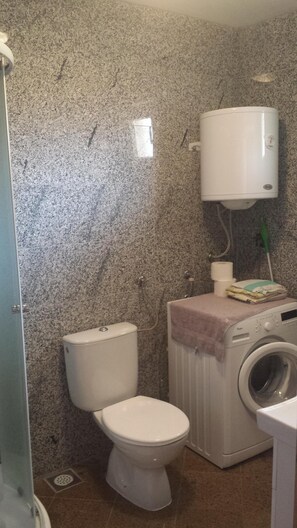 Shower, hair dryer, towels, toilet paper