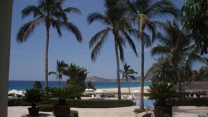 A resort with palm trees, a pool, and a beach view. - Oceanfront Resort Beach Paradise! Great Reviews,  Modern Remodel great location! (San Jose Del Cabo)