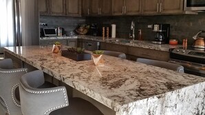 A modern kitchen with a large island, stainless steel appliances, and pendant lighting. - Oceanfront Resort Beach Paradise! Great Reviews,  Modern Remodel great location! (San Jose Del Cabo)