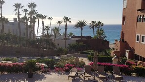A poolside area with lounge chairs and a view of the ocean. - Oceanfront Resort Beach Paradise! Great Reviews,  Modern Remodel great location! (San Jose Del Cabo)
