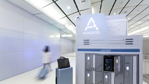 An airport luggage storage area with lockers and a sign for the Avagard Capsule Hotel. - Avagard Capsule Hotel - Suvarnabhumi Airport (Bang Phli)