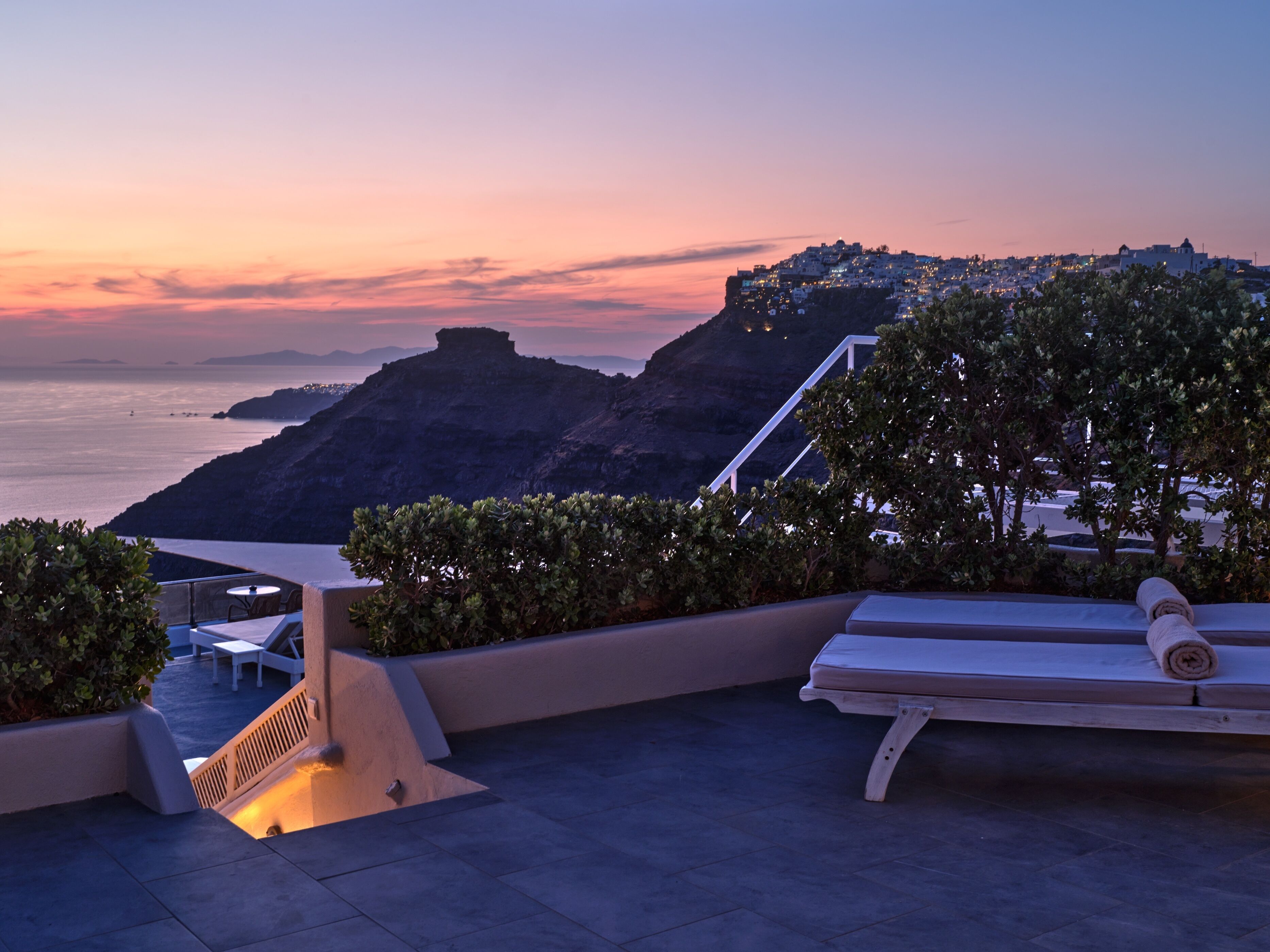 Luxury terrace with sunset view and comfortable seating arranged for relaxation.