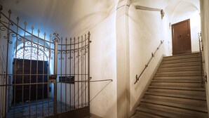 A staircase with a metal railing and a wooden door at the top. - The emotion of living in a Renaissance palace in the heart of Florence (Firenze)