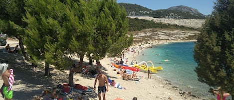 On the beach, sun-loungers