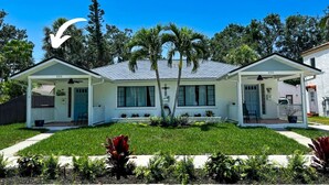 A two-story house with a covered porch and a small front yard. - The Hideaways at Point Pleasant (Pine Side) (Bradenton)