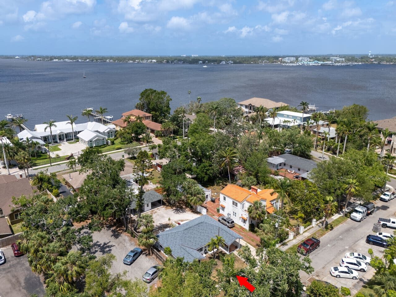 A residential area with houses, a marina, and a large body of water.
