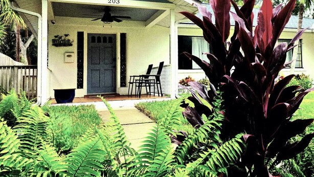 A house with a porch, number 203, and a ceiling fan. - The Hideaways at Point Pleasant (Pine Side) (Bradenton)