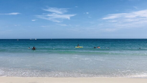 A beach with clear blue water and a sandy shore. - Sunrise Dreamz - Steps from the Beach equipped with all you need! (Fort Pierce)
