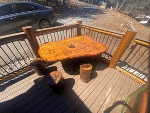 A wooden deck with a table and benches. - Spectacular Mountain Views, Hot Tub, Sledding Yard, BBQ, Fast Wi-Fi (Big Bear)