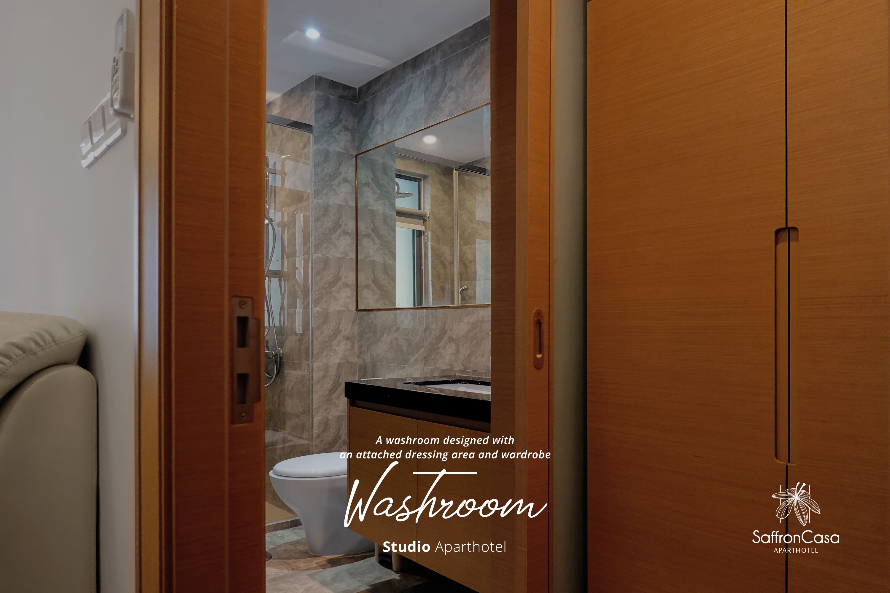 A modern washroom with a marble wall, a sink, and a mirror.