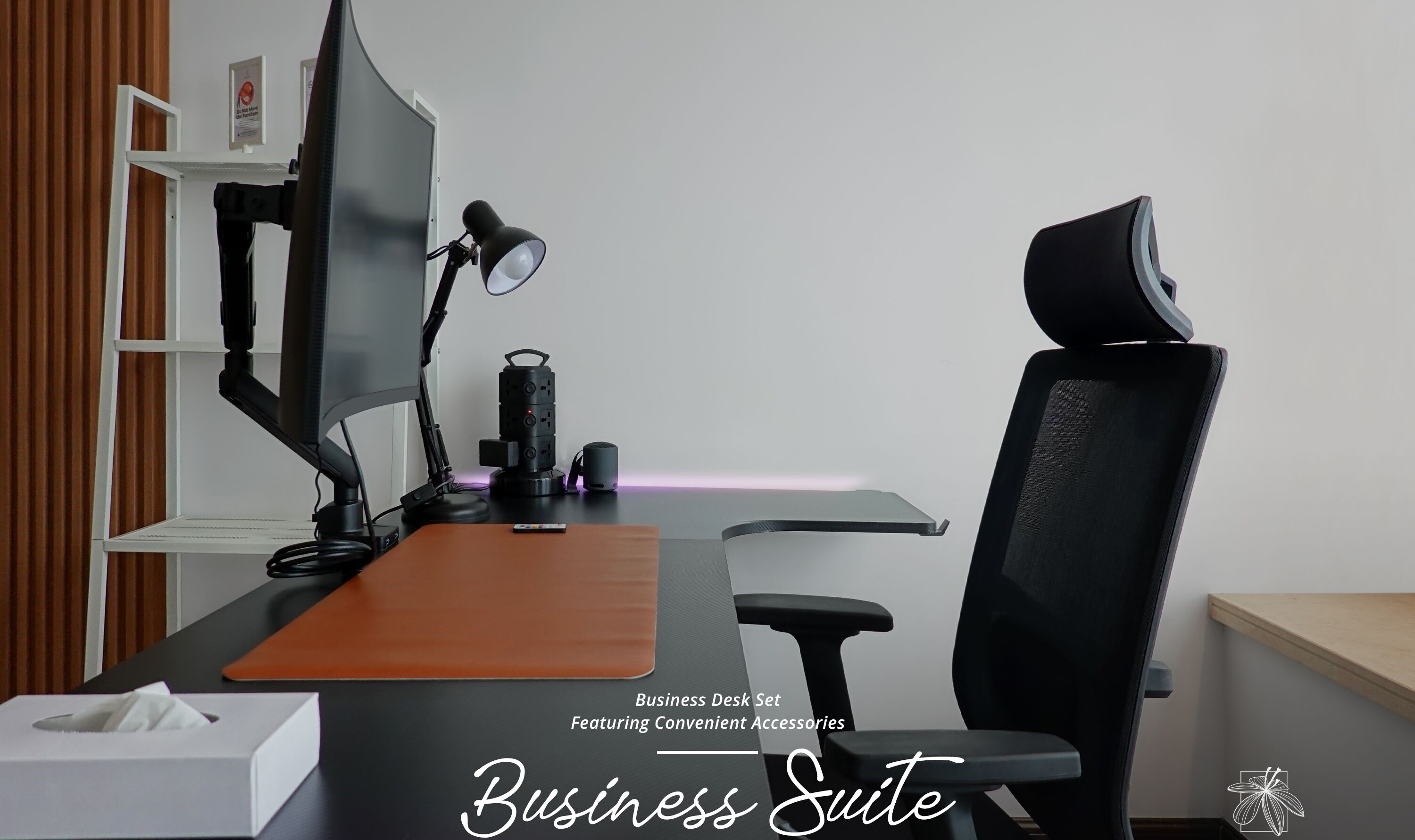 A business desk set with a monitor, desk lamp, and chair.